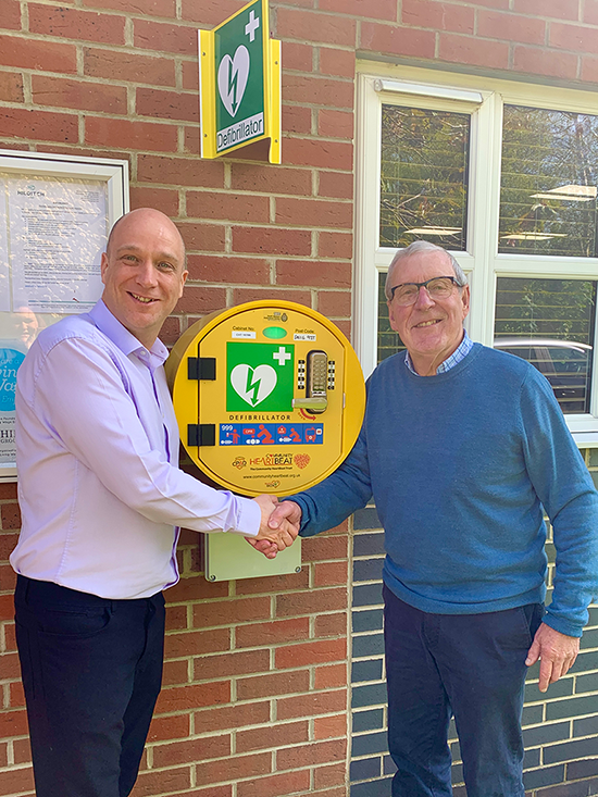 Jamie Howes, Hilditch Group Operation Manager and David Hide from Malmesbury League of Friends at the handing over of a new community defibrillator. MLOF defibrillator donation.