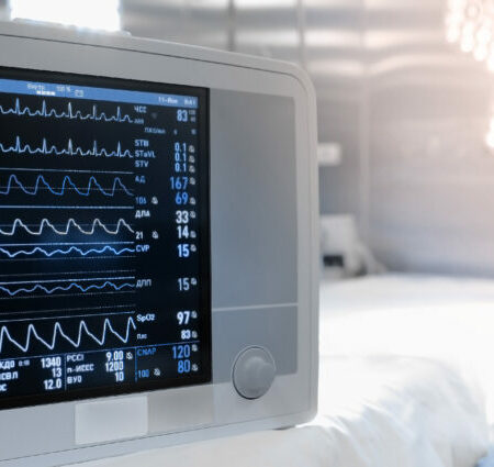 Patient monitor shown in an operating theatre.